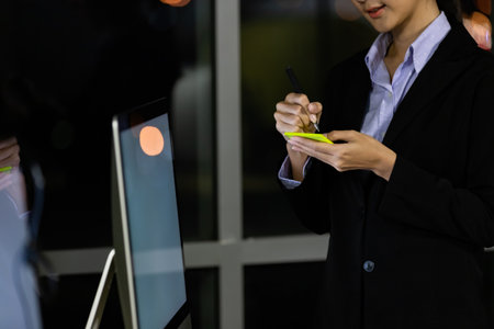 Portrait young business woman at office and write sticky notes to share ideas. Idea modern creative business communication brainstorming conceptの写真素材
