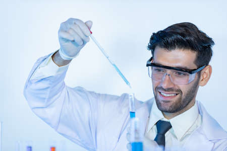 Research scientists analysing test trial new generation vaccine data. They work in a modern laboratory/ Medical center.の写真素材