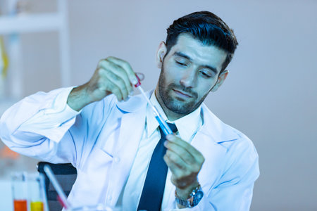 Research scientists analysing test trial new generation vaccine data. They work in a modern laboratory/ Medical center.の写真素材