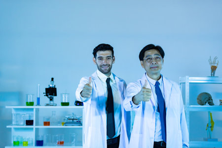 Scientists In Laboratory. Medical workers at work. Portrait of caucasian and asian in modern scientific laboratory working together.の写真素材