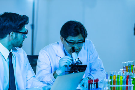 Team of research scientists analysing test trial new generation vaccine data. They work in a modern laboratory/ Medical center.の写真素材