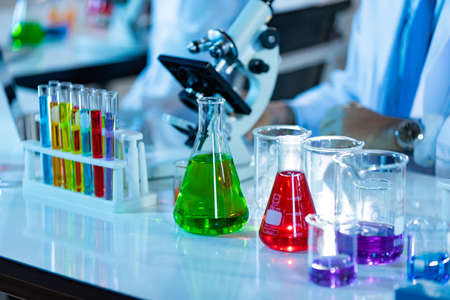 Laboratory Research - Scientific glassware with blur scientist researching background.の写真素材