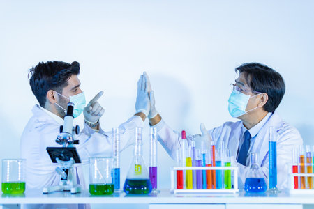 Couple male scientist handshake for success teamwork at laboratory. Scientist portrait shotの写真素材