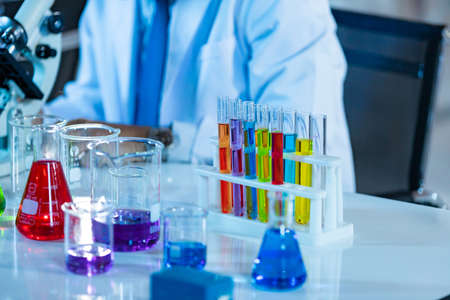 Laboratory Research - Scientific glassware with blur scientist researching background.
