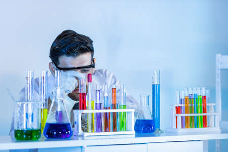 Research scientists analysing test trial new generation vaccine data. They work in a modern laboratory/ Medical center.の写真素材