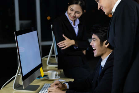 Business team working overtime late at night in call center office for support customer by online and phone. Concept for business at night.の写真素材