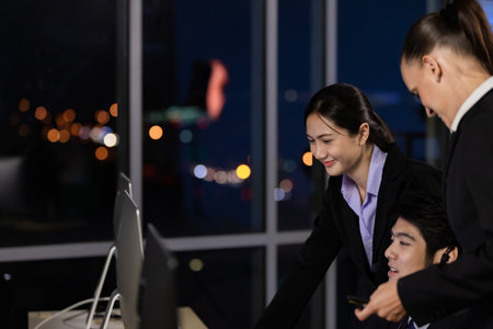 Business team working overtime late at night in call center office for support customer by online and phone. Concept for business at night.の写真素材