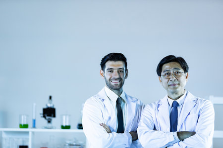 Scientists In Laboratory. Medical workers at work. Portrait of caucasian and asian in modern scientific laboratory working together.の写真素材