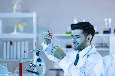 Research scientists analysing test trial new generation vaccine data. They work in a modern laboratory/ Medical center.の写真素材
