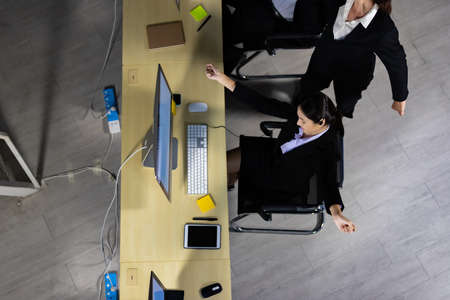 Top view of business team relaxing after working overtime late at night in call center office.の写真素材