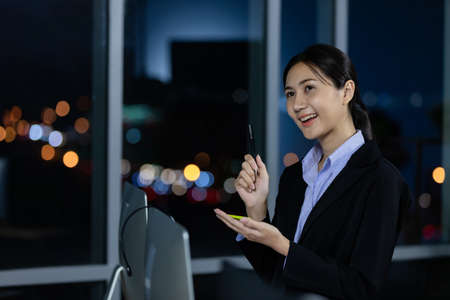 Portrait young business woman at office and write sticky notes to share ideas. Idea modern creative business communication brainstorming conceptの写真素材