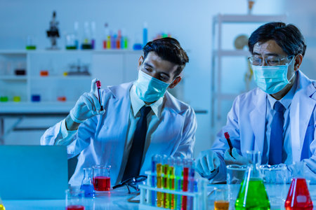 Team of research scientists analysing test trial new generation vaccine data. They work in a modern laboratory/ Medical center.の写真素材