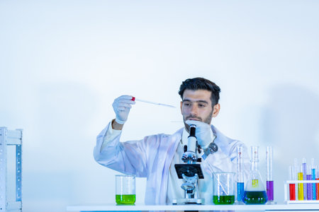 Research scientists analysing test trial new generation vaccine data. They work in a modern laboratory/ Medical center.の写真素材
