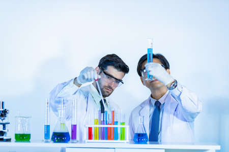 Team of research scientists analyzing test trial new generation vaccine data. They work in a modern laboratory Medical center.の写真素材