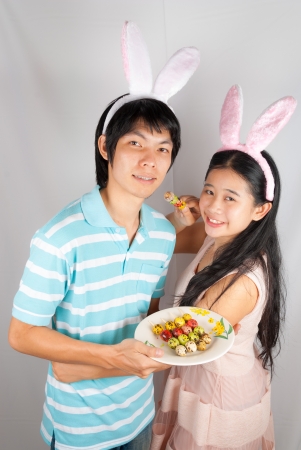 Asian bunny lovers hold Easter eggs  pierced.の写真素材