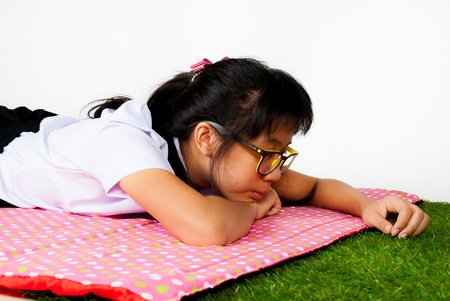 Asian Thai student is playing with grassの写真素材