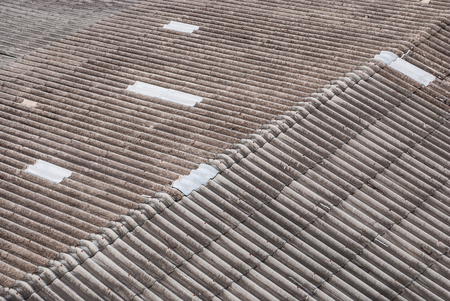 Patched Gray Dirty Wavy Cement Roofの写真素材