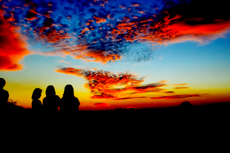 Silhouette of a family playing outdoors at sunset silhouetteの写真素材