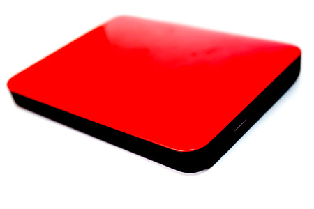 External hard disk drive on red case isolated on the white backgroundの写真素材