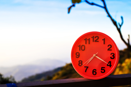 alarm clock on natural landscape season parkの写真素材