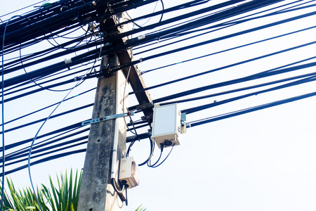 The eleectricity pole with the electric line with the sky.The communication line and electric line share the same pole.の写真素材