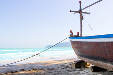 Fishing boat parked on sand floor and sea with blue sky beautiful view holiday concept