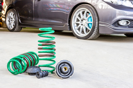Spring suspension with seal rubber part and blur car background for texture and copy space...