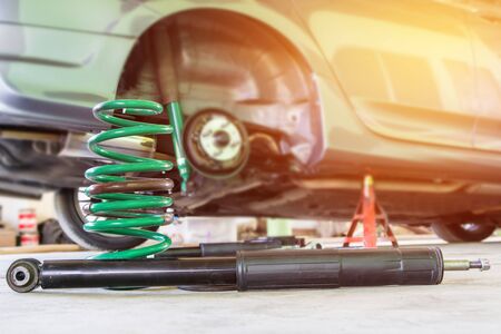 Coil spring and shock absorber on the service shop change and remove old part car maintenance conceptの写真素材