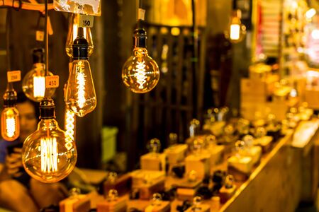 Soft focus of Light bulb in market shop with walking Street