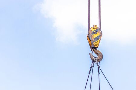 Hook and sling of mobile crane working out site  heavy work industrial and blue sky background