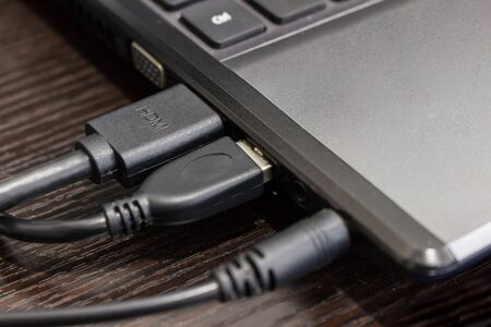 Close up port of computer for audio jack, USB, hdmi cable connecting on the wood table joint conceptの写真素材
