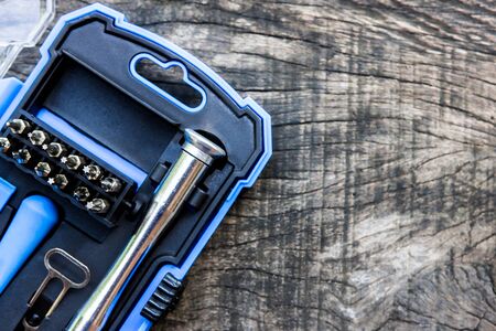 Top view screw driver set and plastic box blue color on the wood floor の写真素材