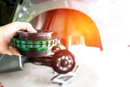 Hand a man setting and adjust level screw of chock absorber spring and car maintenance  background ...