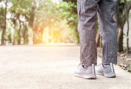 Close up leg walking in park use running sport shoes for safety concept prevent injury from exercise in working dayの写真素材