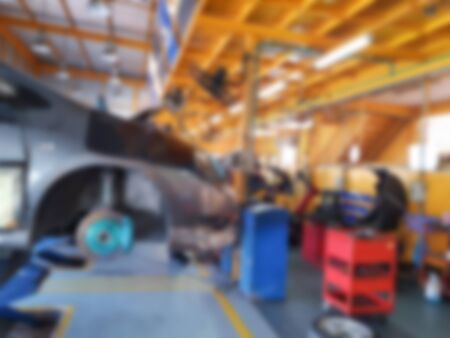 Blur photo service of car Setting Wheel center and service with maintenance concept in shopの写真素材