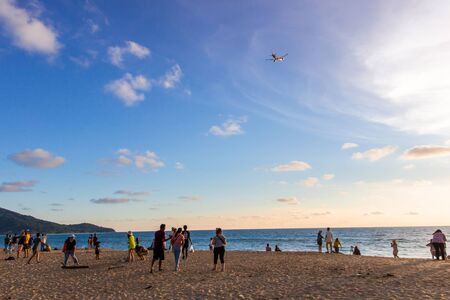 Mai Khao Beach,Phuket,Thailand Mai Khao Beach landmark the tourist take a photo with a plane landing on the beach and blue sky with sunsetのeditorial素材