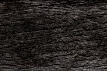Dark brown wood and uneven surfaces for texture and copy space in backgroundの写真素材