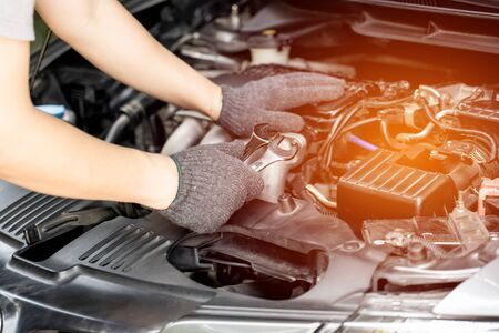 Technician is using a wrench for repair car in car service and maintenance conceptの写真素材
