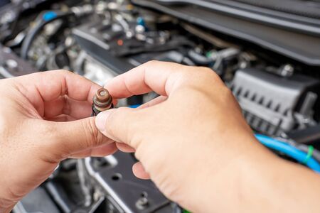 Technician Removing the gasoline  injector part in engine room check hole on part dust and test...