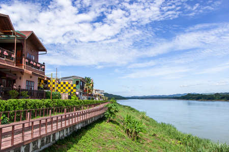 Chiang Khan Kaew Loei,Thailand-July 25,2019 : Tourists walk in working street in market and hotel with river and blue skyのeditorial素材