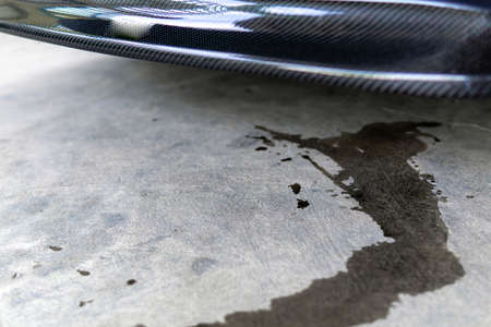 Engine oil stains of car Leak under the car when the car is park on the road  service photo concept for check and maintenanceの写真素材