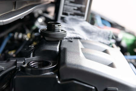 Engine oil cap hole open for Adding engine oil in engine room for level check and engine oil gallon...