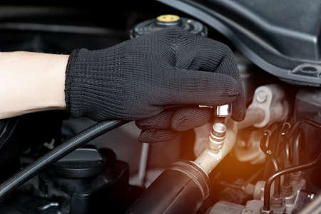 Technician add air conditioning liquid at nozzle pipe In the car's air conditioning systemの写真素材