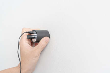 Hand a man use water leaks check machine check leak of water pipe in Concrete wallの写真素材