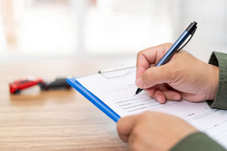 Accident concept of car : The officer write on record check sheet of car accident about the damage...