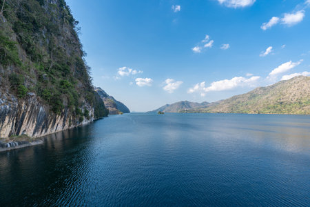 Close up hand a man hold Set of switches for adjusting electric car windows from the box containing the spare parts and use laptop check accuracy before changing to customers in car serviceの写真素材