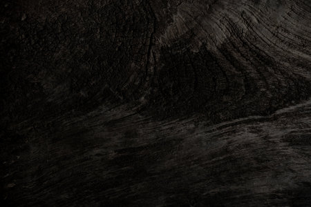 Old brown wood has a rough and uneven surface the natural cracked surface used for background design texture and copy spaceの写真素材