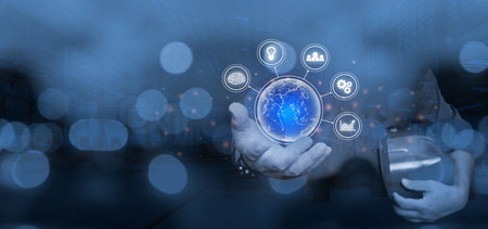 Engineering work and Technology concept : Business global internet connection application technology and digital and a technician holding a safety helmet stand in the factory blurの写真素材