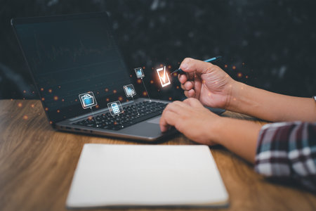 Man select the best choose of business work of icon concept, Man use laptop working in office and note book on table and dark background for txture and copy spaceの写真素材