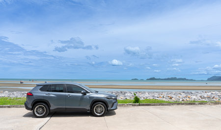 Prachuap Khiri Khan Thailand-May 16,2022 Khao Kalok Beach, SUV Car parking on the road near the beach and beautiful sea views cloudy sky, and mountain view land mark in thailandの写真素材